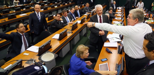 Os deputados Carlos Marun (dir.) e Orlando Silva (PCdoB-SP, sentado, à esq.) discutem no começo da sessão da comissão nesta segunda-feira
